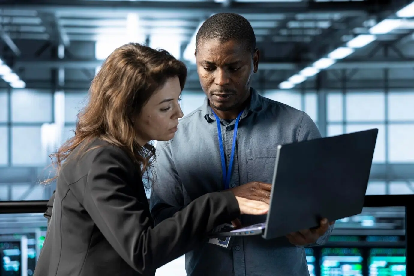 ИТ-специалисты серверного хаба общаются, используя ноутбук, чтобы настроить параметры питания.